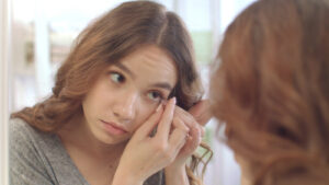 woman inserting contact lenses