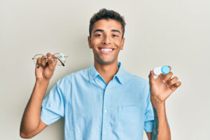 man with glasses and contacts in his hands