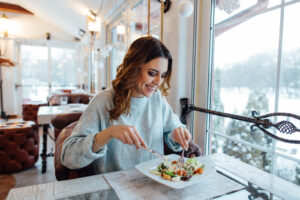 woman enjoying a colorful salad