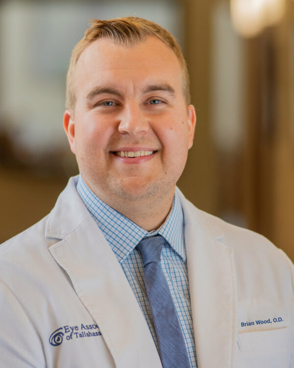 Dr. Wood headshot, smiling in white lab coat